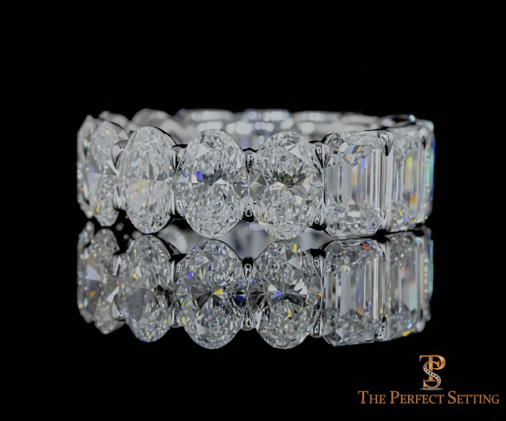 Multi-faceted eternity band with alternating emerald cut and oval diamonds — designed by Amy Certilman at The Perfect Setting