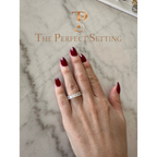 The Perfect Setting, Inc. emerald-cut diamond eternity band worn on a finger with dark red nail polish.