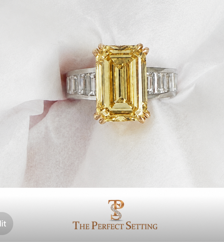 A yellow emerald-cut diamond ring with a yellow gold band and side-cut diamonds, displayed on a white textured fabric background with a banner at the bottom featuring the 'The Perfect Setting' logo.