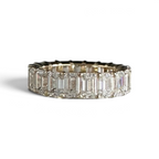 The Perfect Setting, Inc. custom emerald-cut diamond eternity band featuring sparkling stones in a gold setting.