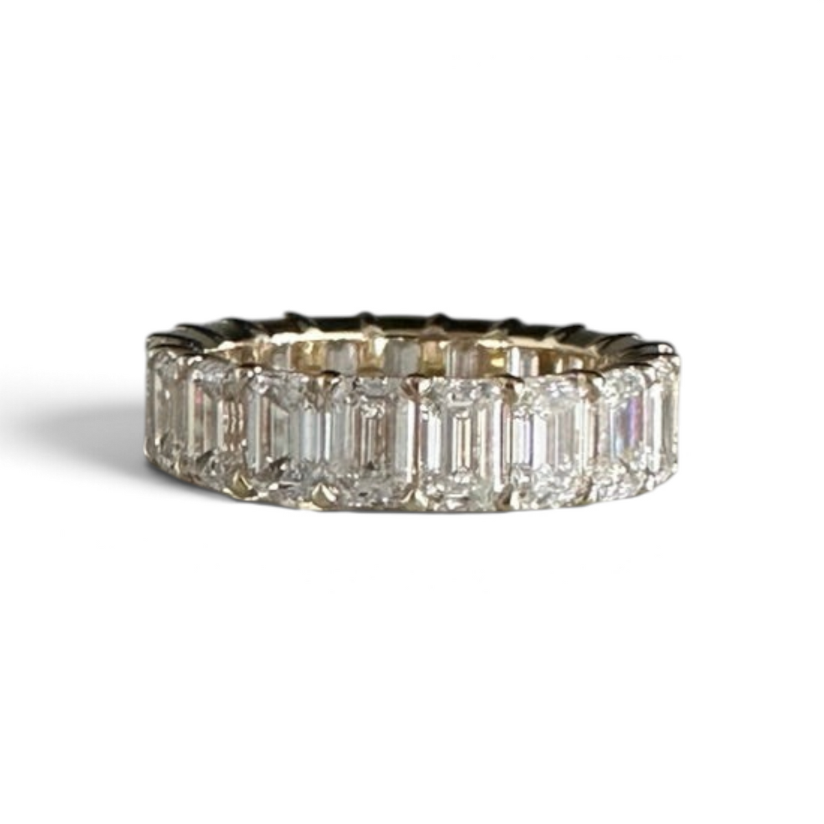 The Perfect Setting, Inc. custom emerald-cut diamond eternity band featuring sparkling stones in a gold setting.