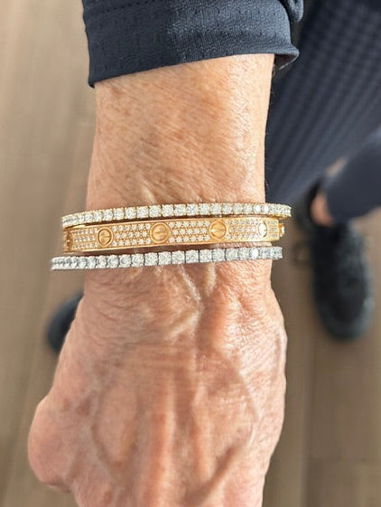 Person wearing two soft flex lab diamond bracelets with cartier stack