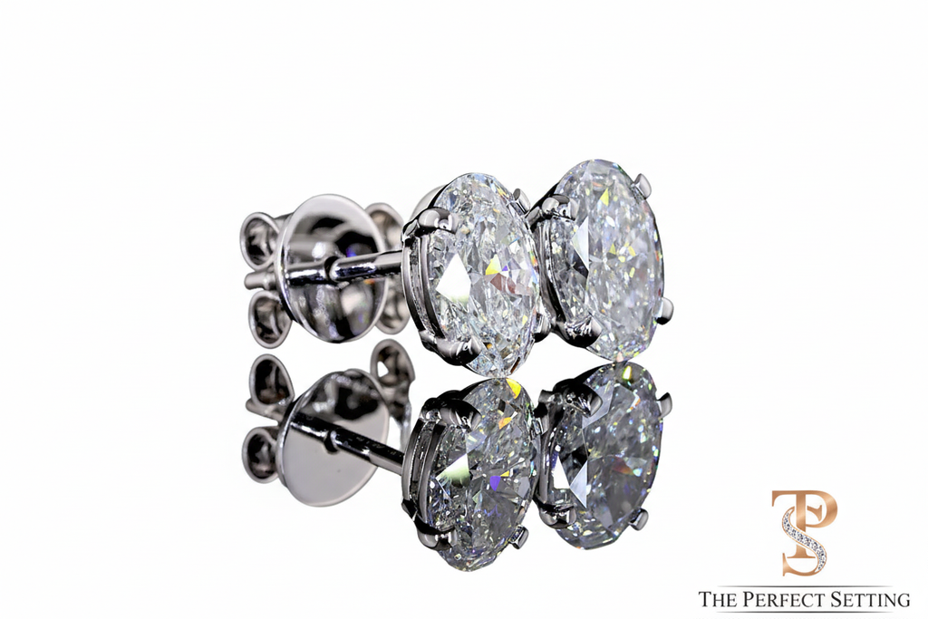 Oval diamond stud earrings with white background and logo