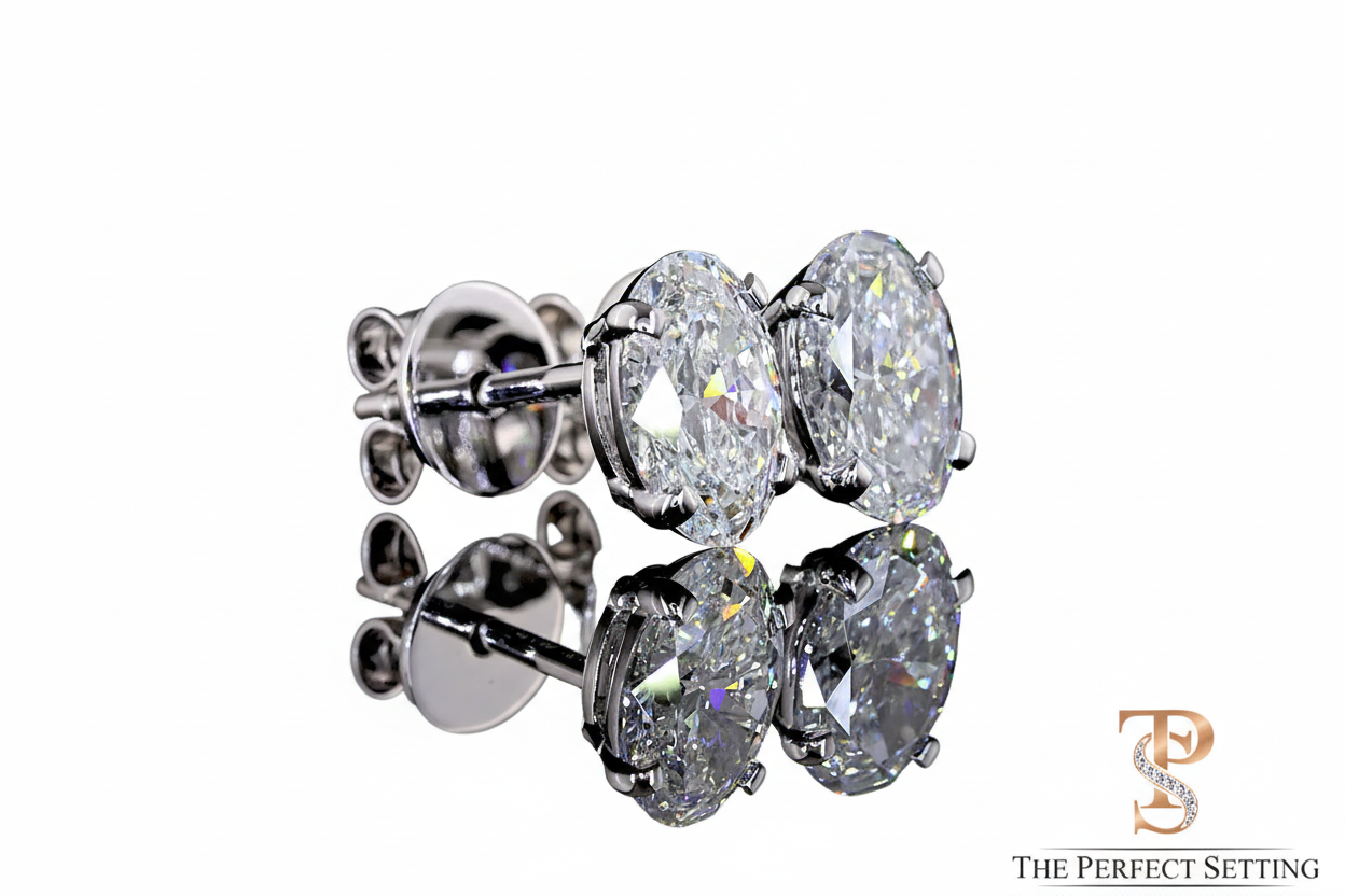 Oval diamond stud earrings with white background and logo