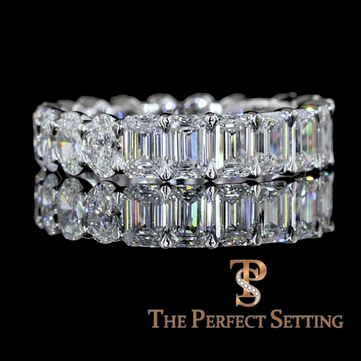 The Perfect Setting, Inc. platinum eternity band featuring alternating emerald and oval cut diamonds on black background