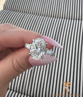 The Perfect Setting, Inc. platinum engagement ring with a 3 carat oval diamond and tapered baguette side stones.