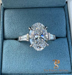 The Perfect Setting, Inc. platinum engagement ring featuring a 3 carat oval diamond with tapered baguette side stones.