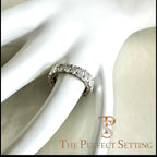 The Perfect Setting, Inc. platinum eternity band featuring alternating emerald and oval cut diamonds on a white display.