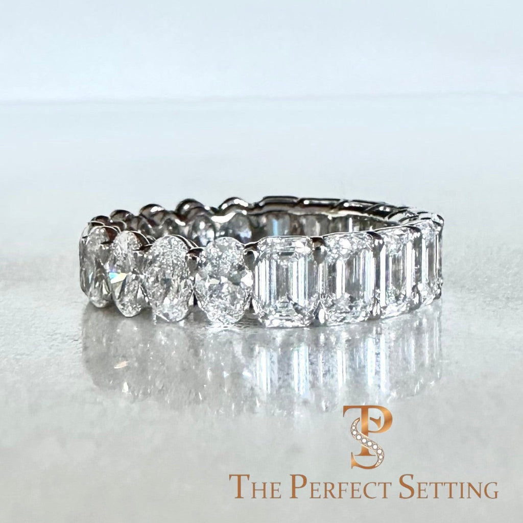The Perfect Setting, Inc. custom platinum eternity band featuring alternating emerald and oval cut diamonds on a textured background.