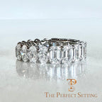 The Perfect Setting, Inc. custom platinum eternity band featuring alternating emerald and oval cut diamonds on a textured background.