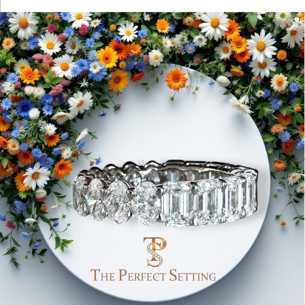The Perfect Setting, Inc. platinum eternity band featuring alternating emerald and oval cut diamonds on a floral base.