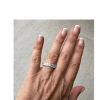 The Perfect Setting, Inc. platinum eternity band featuring alternating emerald and oval cut diamonds on a hand.