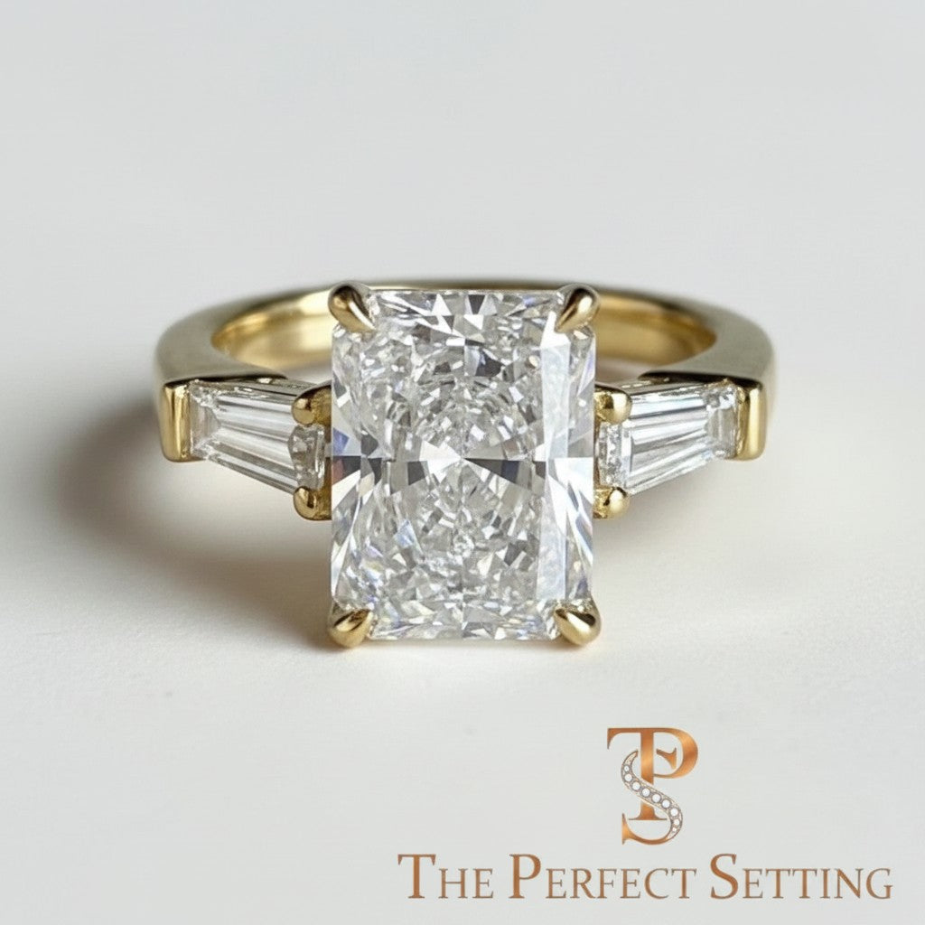 The Perfect Setting, Inc radiant cut diamond engagement ring with tapered baguette side stones in 18K yellow gold