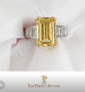 The Perfect Setting, Inc emerald cut vivid yellow diamond engagement ring with baguette side stones on white fabric