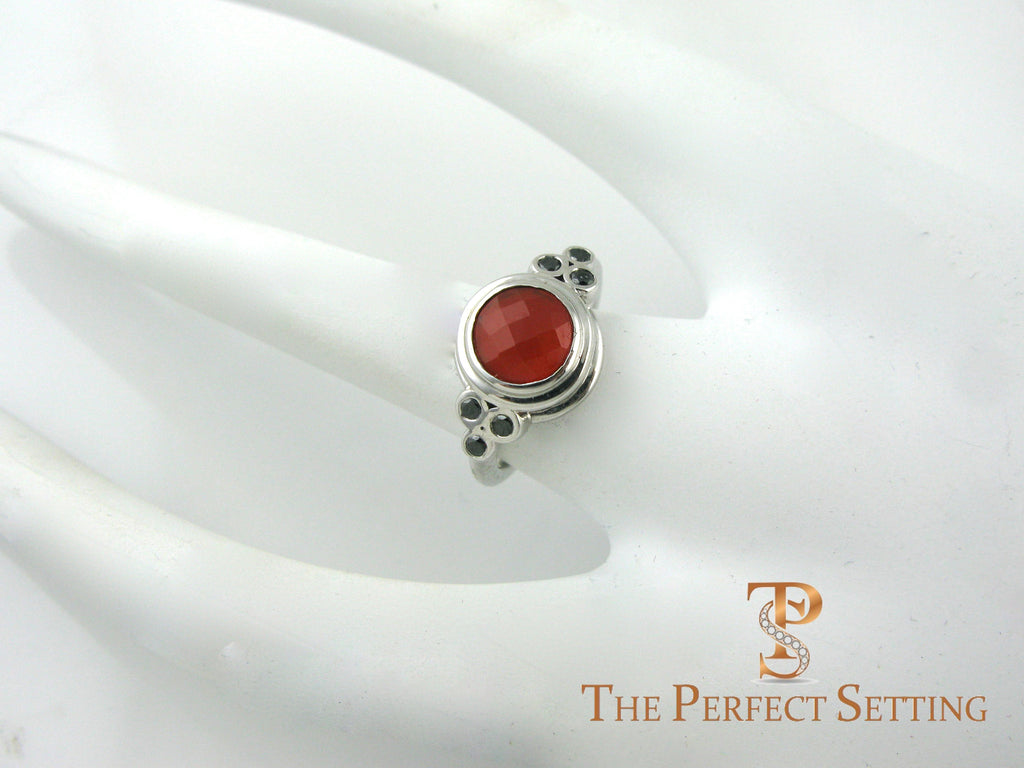 cornelian ring with black diamond accents on hand