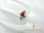 cornelian ring with black diamond accents on hand
