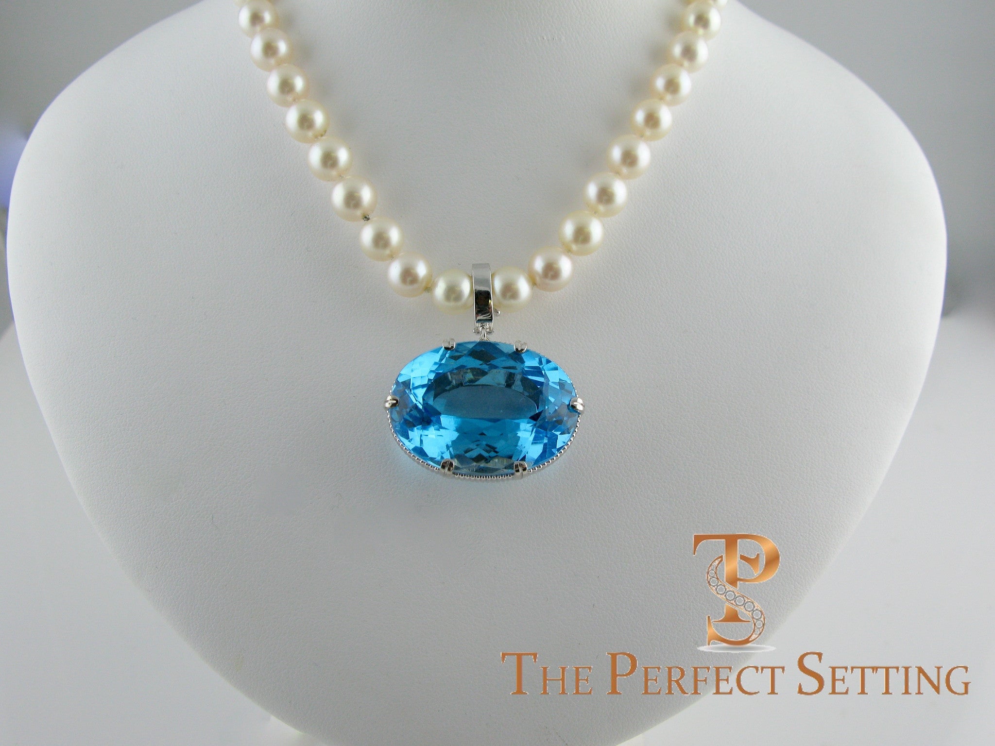 large tourmaline pendant on pearl necklace