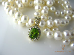 Diamond and tourmaline enhancer on pearl necklace