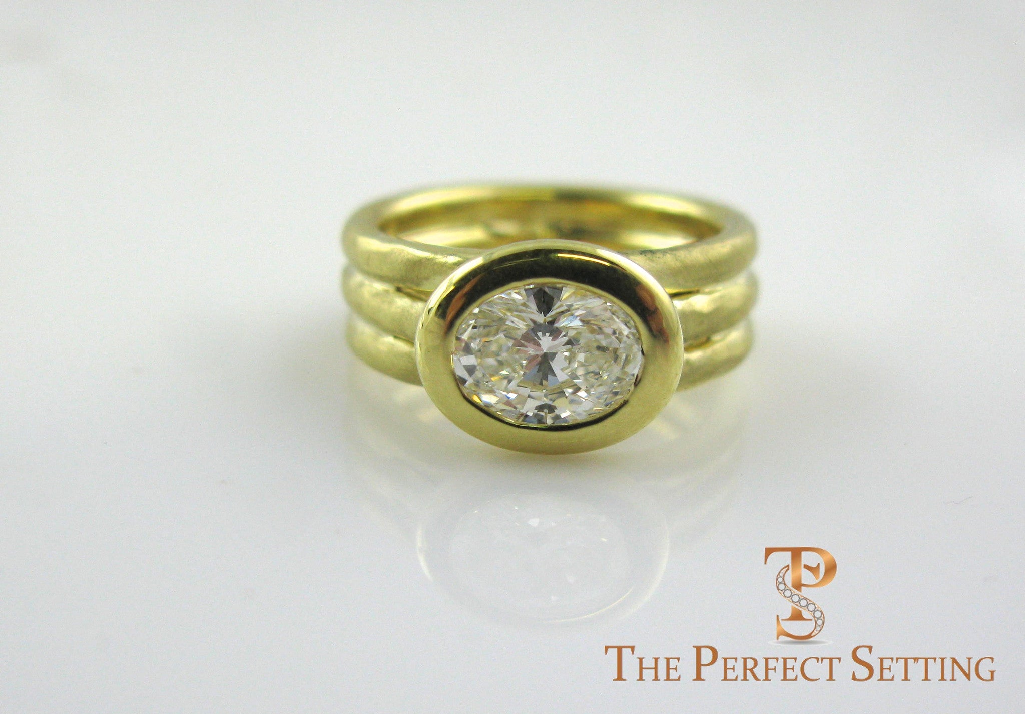 Oval Diamond 18K yellow gold bezel setting right hand ring