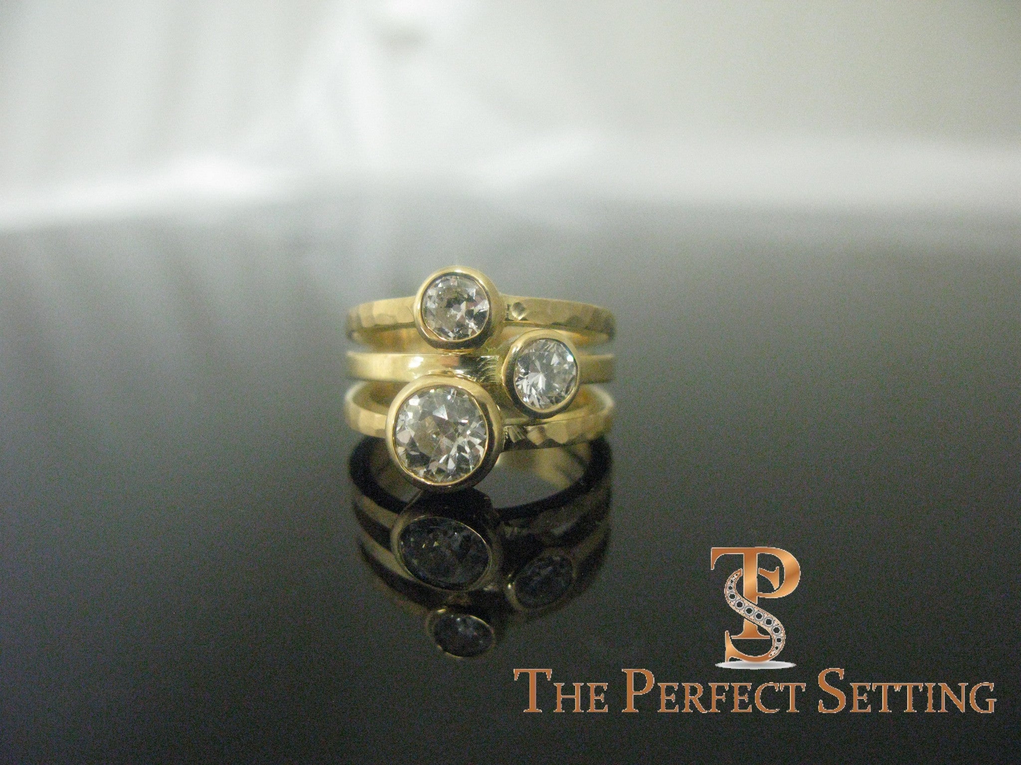 Yellow gold bezel set three stone ring