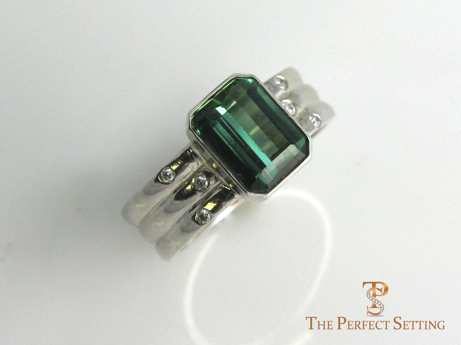 Bezel set tourmaline and diamonds in 14K white gold.