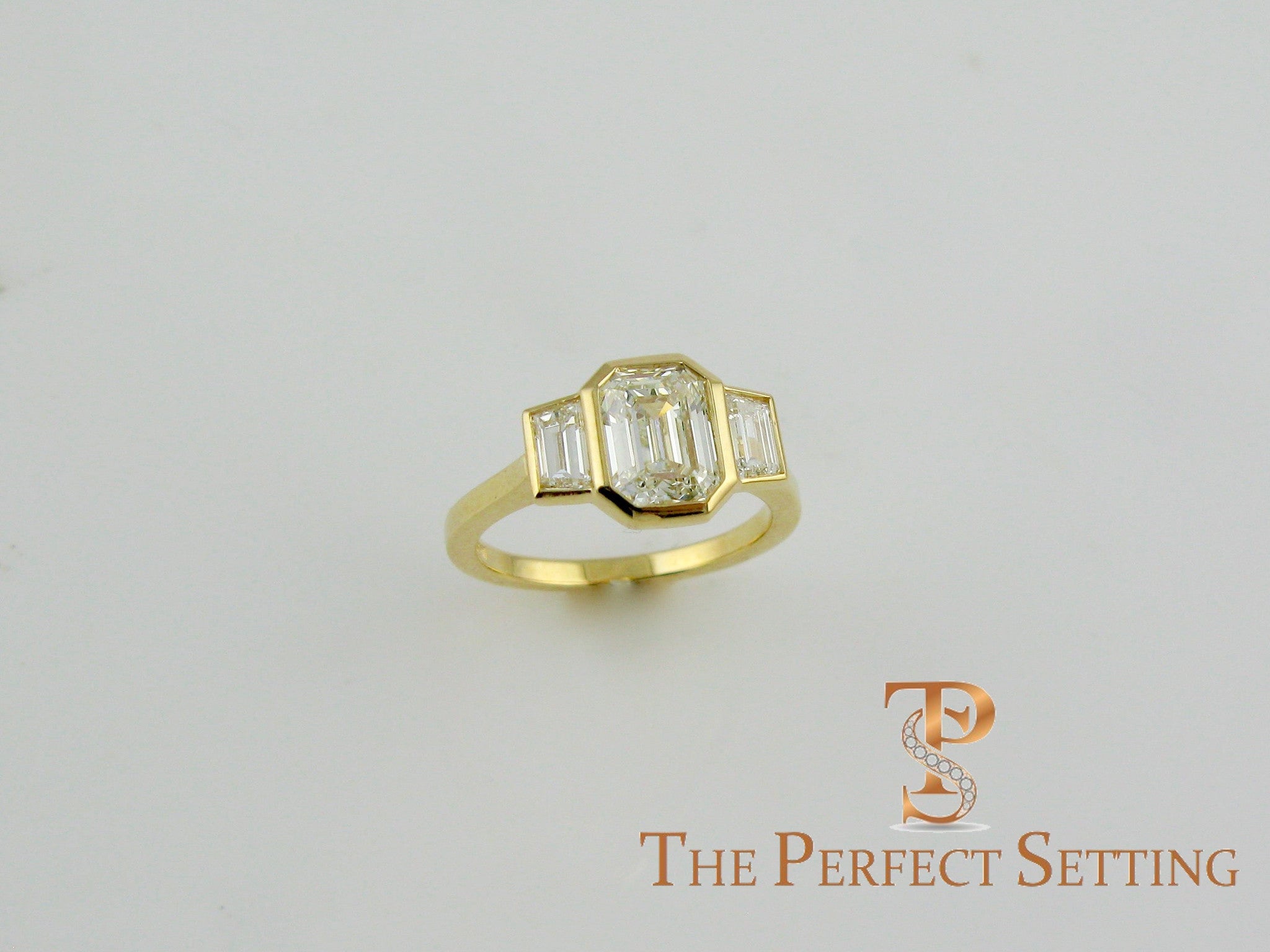3 stone emerald cut diamond custom bezel set ring