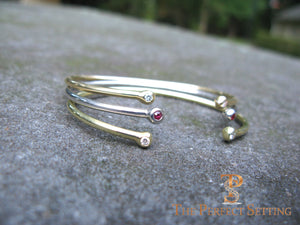 18K gold wire bangle with diamond and rubies