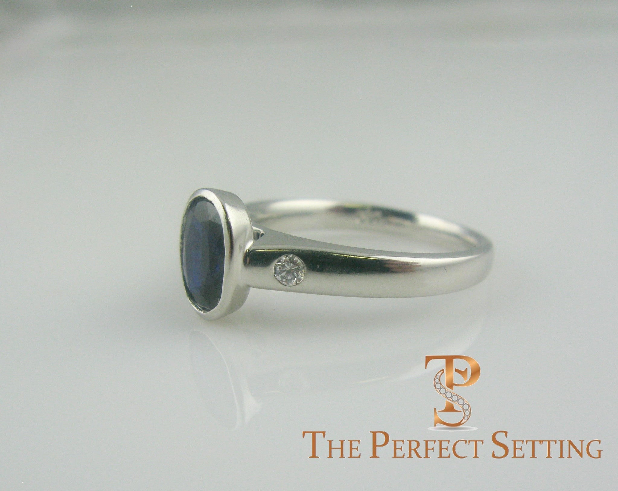 Bezel Set Oval Sapphire and Diamond Ring