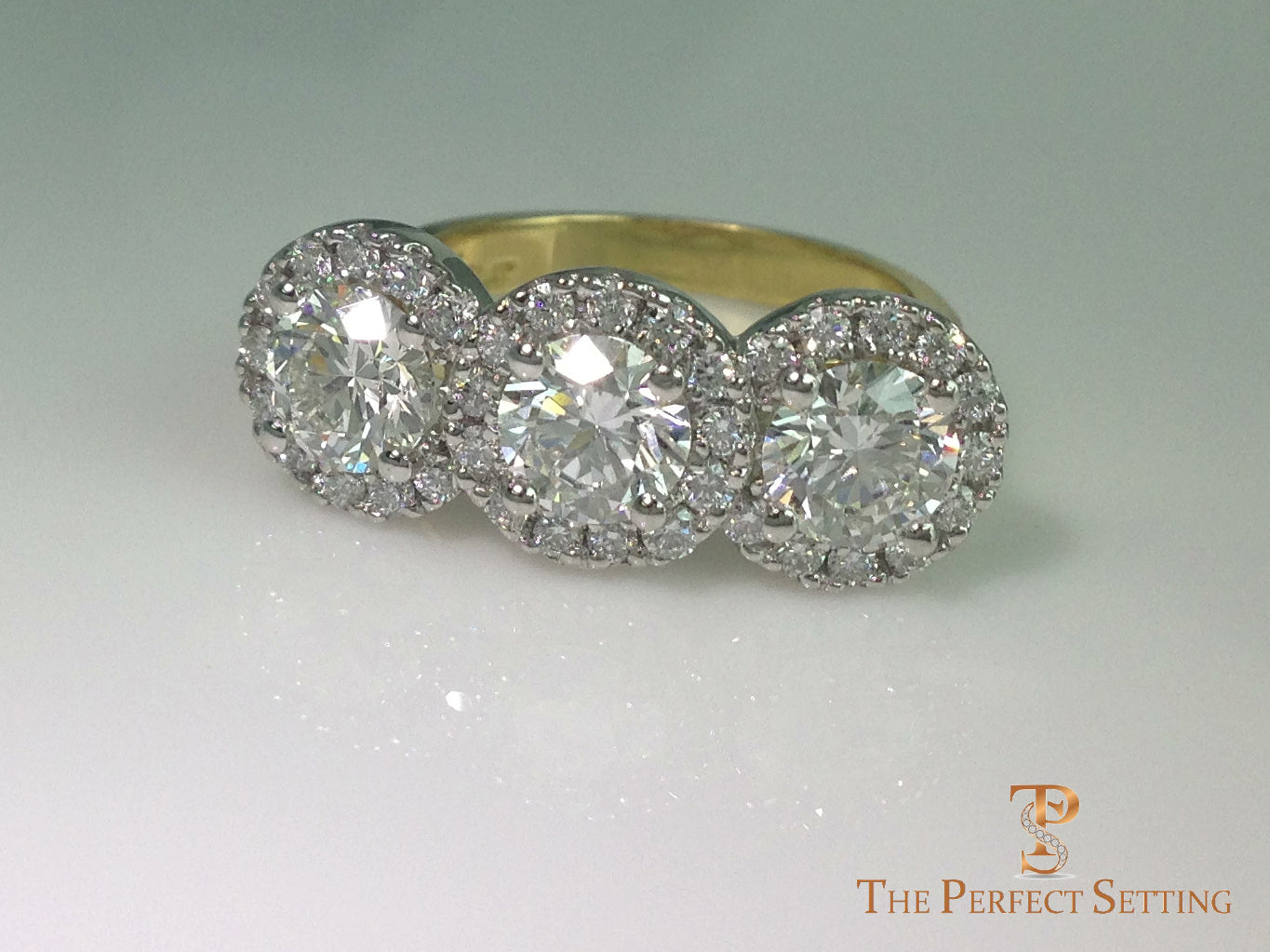 three stone diamond halo ring on side