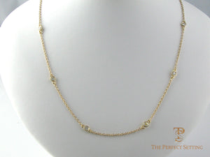 Diamonds bezel set on cable chain in 14K yellow gold